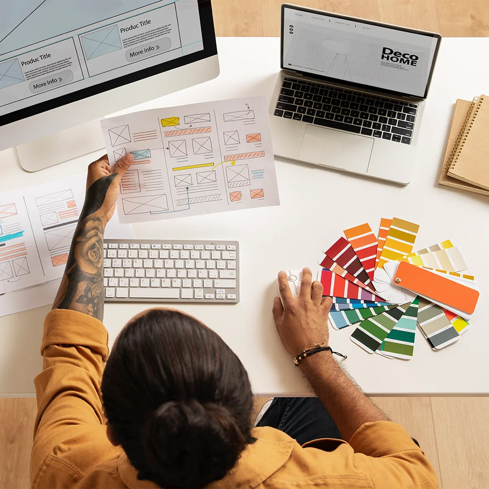 Person reviewing website mockups and color palettes for design project.