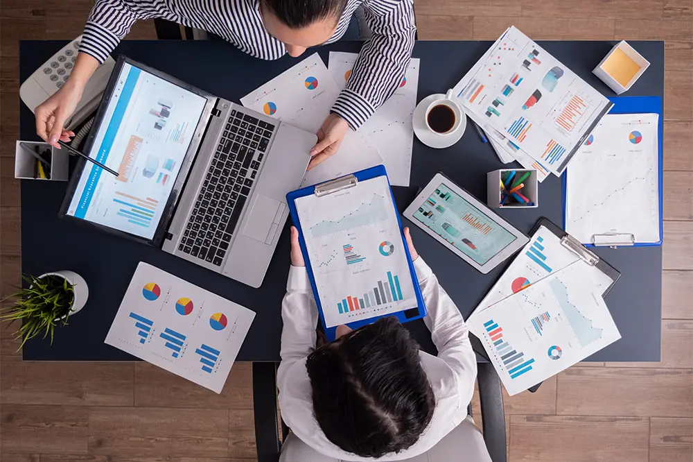 Marketers reviewing performance data on laptops and tablets